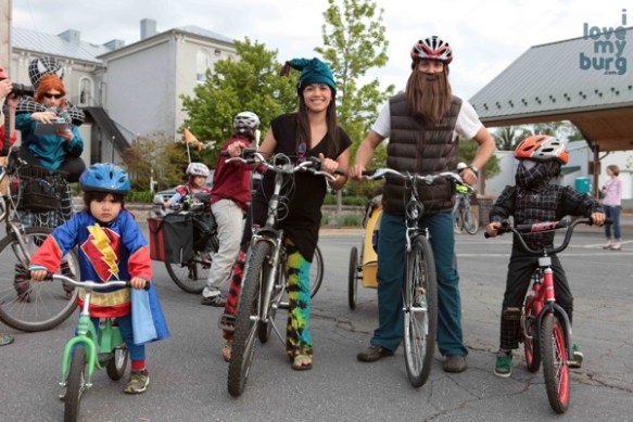family in costume on bikes