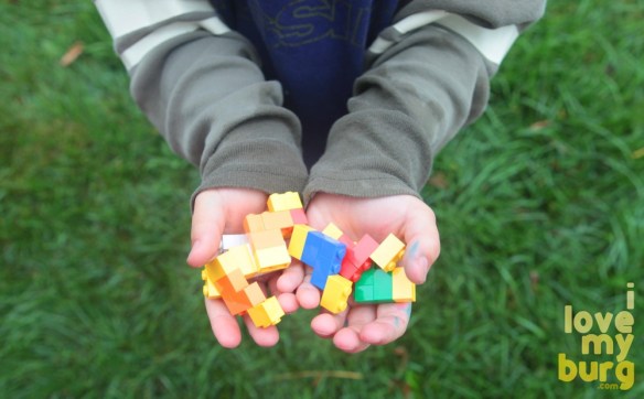kids hands holding LEGOS