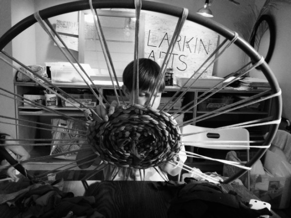 boy weaving rug