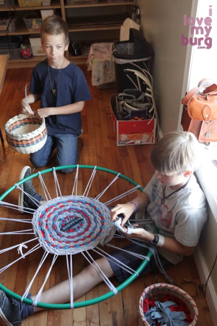 boy weaving rug