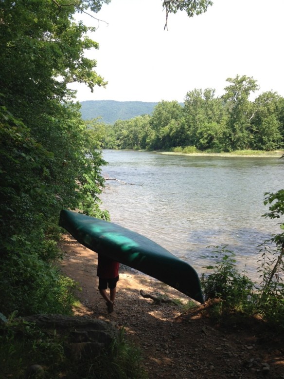 man carrying canoe