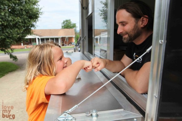 father and son fist bump