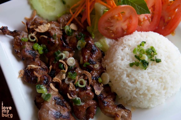 MARINATED GRILLED PORK (OR CHICKEN). grilled pork or chicken with carrots, tomato, cucumbers, jasmine rice, and clear sauce.